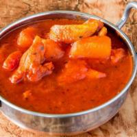 Chicken Vindaloo · Chicken cooked with potatoes in a hot and tangy sauce. Served with basmati rice.