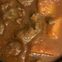Lamb Vindaloo · Tandoori chef classic, boneless lamb with potatoes cooked in tangy hot curry. Served with ba...