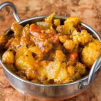 Aloo Gobhi · Cauliflower and potatoes sautéed with onions and tomatoes. Served with basmati rice.
