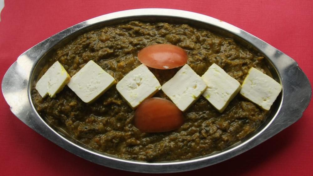 Saag Paneer · Homemade cheese and spinach simmered in a cream sauce. Served with basmati rice.