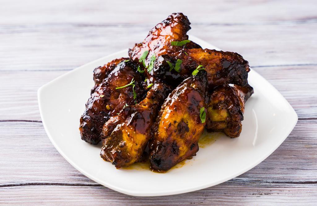 Mango Habenero Wings · Charred grilled wings cooked in mango habanero sauce.