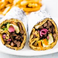Beef Shawarma Wrap · Yogurt and spice marinated boneless beef, green mix, pickled onions, and white sauce.