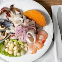 Ceviche Mixto · Peruvian style seafood and fish salad tossed with onions and fresh lime juice.