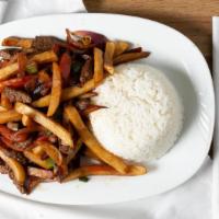 Lomo Saltado De Pollo · Sliced of chicken sautéed with tomatoes and onions and French fries.
