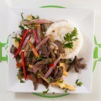 Lomo Saltado · Sliced Beef Chunks Sauteed With Red Onions and Tomatoes, Served Over French Fries.