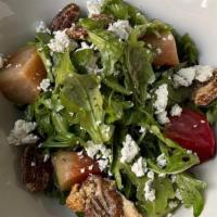 Baby Arugula · Roasted golden beets, oranges, candied walnuts, herb goat cheese, champagne vinaigrette