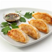 Pork Dumplings · Six pieces of customer's choice of steamed or fried pork dumplings.