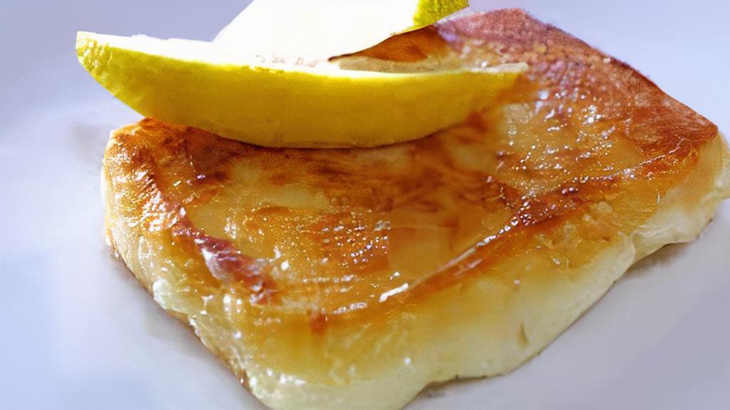 Saganaki · Pan-fried kefalograviera cheese from epirus, anointed with lemon.