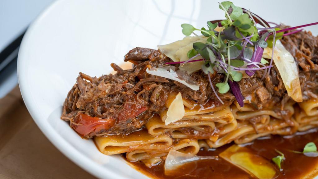Pacchieri Genovese · Slow braised short rib rage, topped with shaved parmigiana & truffle oil.