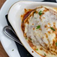 Lasagna · Layered pasta and mozzarella with ricotta, beef, pork and veal in alta cucina tomato sauce.
