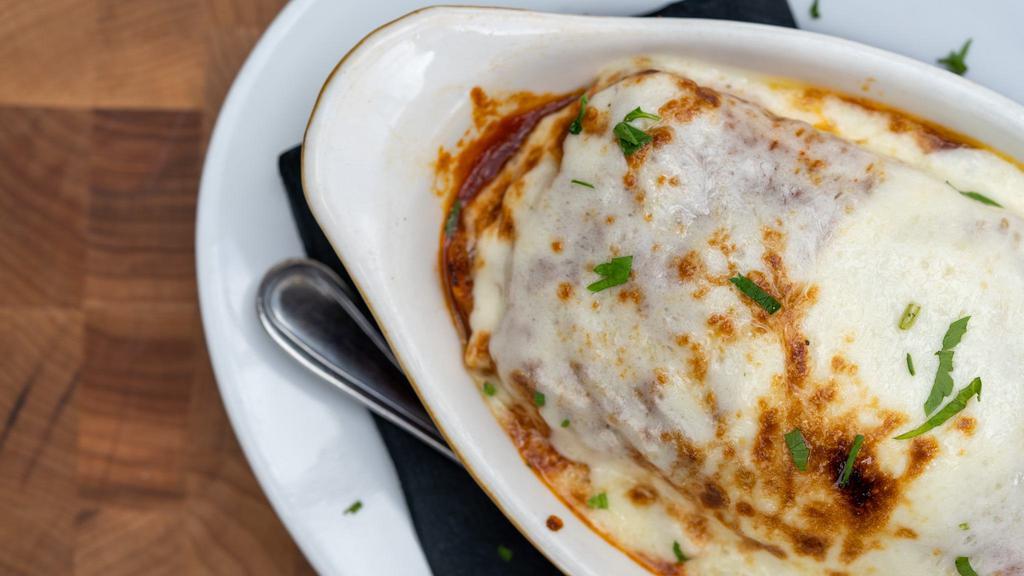 Lasagna · Layered pasta and mozzarella with ricotta, beef, pork and veal in alta cucina tomato sauce.