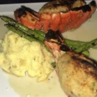 Stuffed Lobster Tail · Twin Lobster Tails Loaded with Crab Meat & Drizzled with Scampi Sauce. Served with Sides of ...