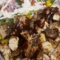 Jerk Chicken Over Rice · Jerk chicken over rice or mixed with lettuce and a Mediterranean salad.
