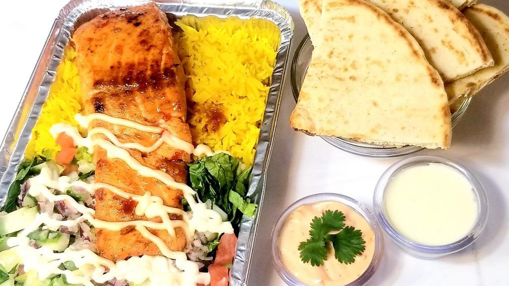 Honey Glazed Salmon Over Rice · Honey Glazed Salmon over rice or mixed with lettuce and a Mediterranean salad. Served with pita and soda.