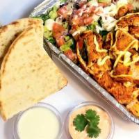 Grilled Chicken  Over Rice  · Grilled chicken over rice or mixed with lettuce and a Mediterranean salad. Served with pita ...