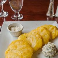 Tostones De Yuca · A crispy flat fried yuca toston style served with garlic creamy sauce and spinach dip.