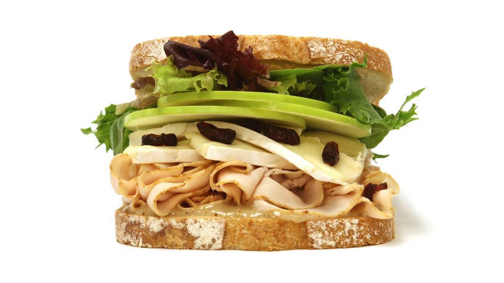 Turkey Brie Sandwich · Smoked turkey brie, dried crandberry, green apple, mixed greens and low fat honey mustard.