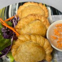 Curry Puff · Savory pastry pockets stuffed with curried chicken and potatoes.