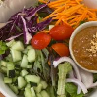 Thai Salad · Mixed greens, lettuce, carrot, cucumber, onion, tomato. Served with peanut dressing.