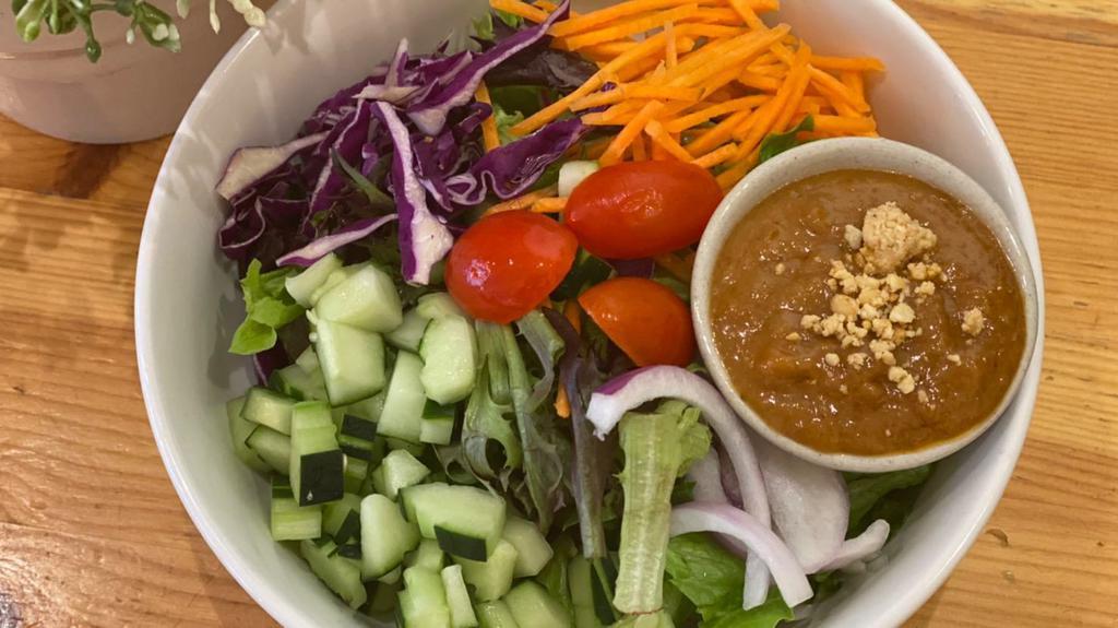 Thai Salad · Mixed greens, lettuce, carrot, cucumber, onion, tomato. Served with peanut dressing.