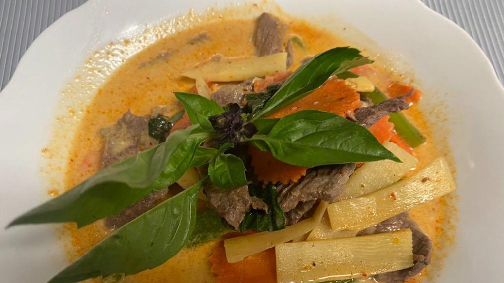 Gaeng Dang · Red curry. Thai style red curry with bamboo shoot, basil leaves, carrot, eggplant and bell pepper simmered in coconut milk.