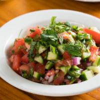 Arabic Salad · finely chopped tomato, cucumber, onion, & herbs, with olive oil and squeeze of lemon