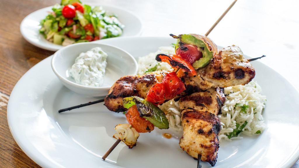 Chicken Grill · grilled chicken marinated in house-made spice blend, served over herbed rice, grilled vegetable skewer, pickled red cabbage & cucumber yogurt