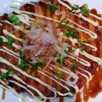 Okonomiyaki · Japanese style savory pancake filled with cabbage and scallion. Top with bonito flakes, okon...