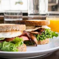 E.L.T. · Bacon, over easy eggs, lettuce, tomato and herb aioli on grilled sourdough.