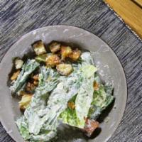 Caesar Salad · Romaine, creamy parmesan, garlic croutons, shaved reggiano.