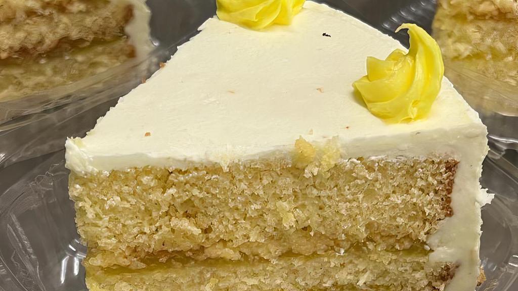 Slice Of Lemon Cake · Moist Vanilla cake with lemon filling and iced with creamy buttercream!!