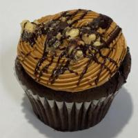 Twix Caramel Colossal Cupcake · Delicious rich Chocolate cupcake with caramel buttercream, crushed Twix cookies and drizzled...