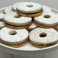 Linzer Tart Cookie · Buttery Flakey Cookies filled with raspberry jam and topped with powdered sugar