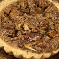 Pecan Tart · Flakey buttery cookie tart filled with pecan pie filling.