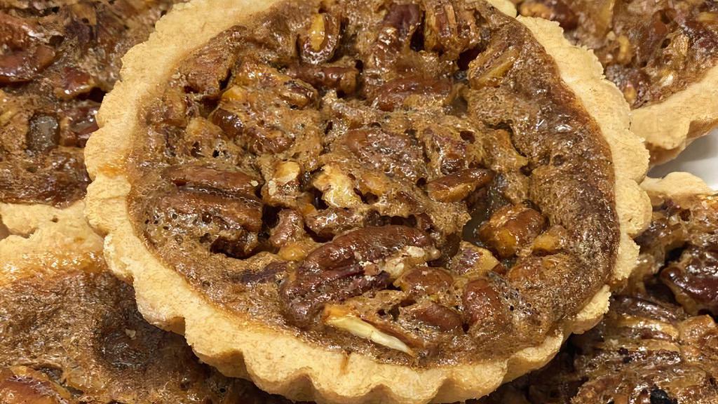 Pecan Tart · Flakey buttery cookie tart filled with pecan pie filling.