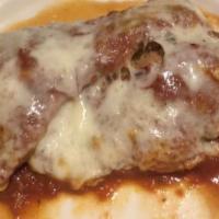 Chicken Parmigiana · Chicken cutlet fried, topped with tomato sauce, and mozzarella cheese.