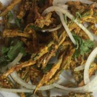 Bhindi Churi Muri · Crisp okra spiced with tart chaat masala and lime, tossed with red onions.