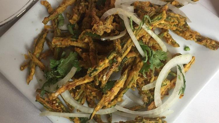 Bhindi Churi Muri · Crisp okra spiced with tart chaat masala and lime, tossed with red onions.