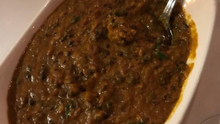 Dal Bukhara · North Indian special mix black lentil slow cooked in aromatic spices.