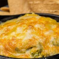 Baked Spinach And Artichoke Dip · A bubbly blend of 5 cheeses, spinach and tortilla chips