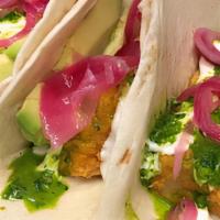 Baja Tacos · Atlantic cod, cilantro pesto, pickled red onion, sliced avocado, and house-made crema