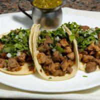 Authentic Tacos · Three chicken or pork tacos with cilantro and chopped onions served with sour cream and auth...