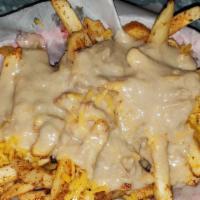 Kilauea Fries · Basket of fries tossed in Cajun seasoning and fresh garlic topped with TOS vegan gravy and r...