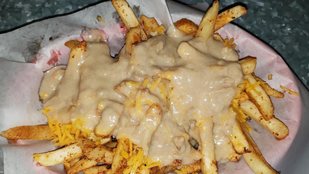 Kilauea Fries · Basket of fries tossed in Cajun seasoning and fresh garlic topped with TOS vegan gravy and real or vegan cheese.
