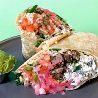 Spiced Carne Asada Burrito · Pan-seared flank steak burrito with your choice of toppings and sauce