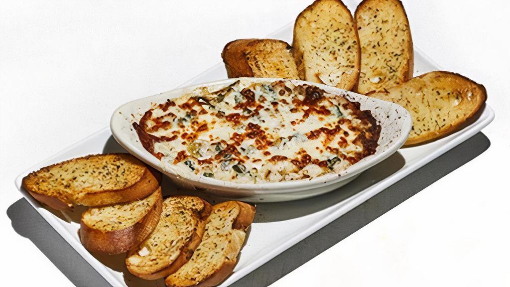 Spinach Artichoke Dip · A rich blend of five cheeses baked with spinach and artichokes.  Served with garlic toast points.