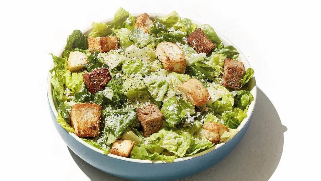 Caesar Salad · All hail the perfect salad. Freshly chopped romaine lettuce tossed with all-natural caesar dressing and topped with shaved Parmesan and house-made croutons.