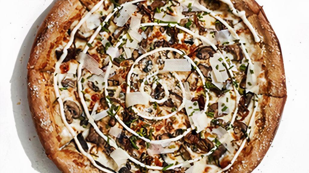Holy Shiitake · An olive oil and garlic base with roasted shiitake, button and portobello mushrooms, caramelized onions, mozzarella and Wisconsin Aged White Cheddar cheese. Finished with fresh chives, shaved Parmesan, a garlic aioli swirl and a spritz of black truffle oil..