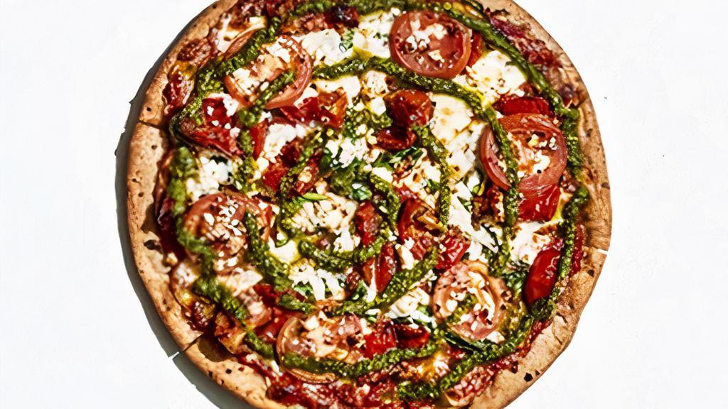 Gluten-Free Kosmic Karma · This pie starts with gluten-free crust (available only in size small) and Mellow red sauce covered with spinach, roasted tomatoes, mozzarella, fresh Roma tomatoes and authentic sheep’s milk feta cheese. Topped with a pesto swirl.