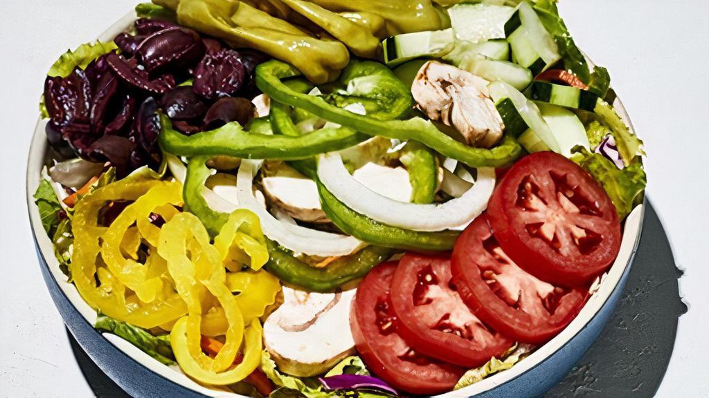 Vegan Greek Salad · Romaine and iceberg lettuce tossed with shredded carrots and red cabbage. Topped with sweet onions, cucumbers, green peppers, mushrooms, Roma tomatoes, pepperoncinis, banana peppers, Kalamata olives. We've taken the cheese out.